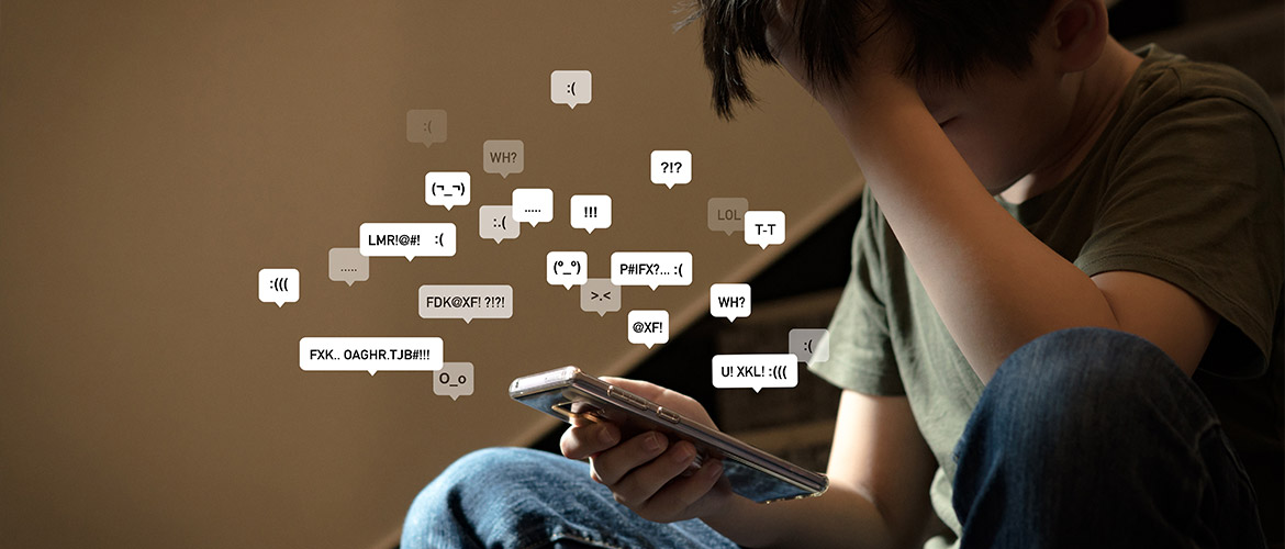 Adolescent stressé par des messages agressifs et insultes sur son smartphone, illustrant les risques de cyberharcèlement et d'expositions aux dangers en ligne